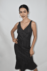 Woman wearing a black denim V-neck Midi dress